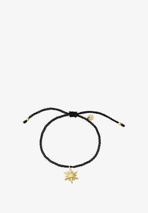 Juodasis pintas apyrankė su auksiniu saulės pakabučiu ir mažu aukso akcentu. Reguliuojamas užsegimas su suplukta juoda virvele.