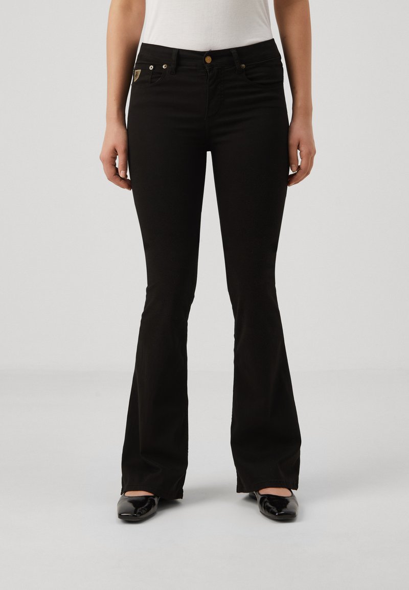 Svarta utställda jeans i en bomullsblandning, med fem fickor, i guldfärgad metall och en åtsittande midja med en medelhög design.