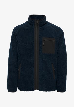 Navy blue fleece jacket with high collar and zip front, featuring black zippered chest pocket and side pockets, textured fabric.