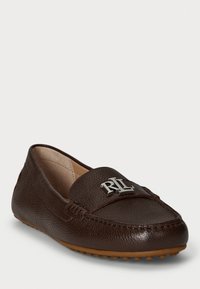 Brown leather loafers with a textured finish, featuring a silver logo accent on the front and a rubber sole with small nubs.