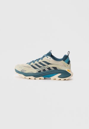 Lightweight running shoes in cream and teal with mesh upper, sturdy sole, textured accents, and Vibram branding on side.