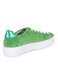 Green suede sneaker with a white rubber sole, featuring a metallic green heel accent and white laces. Smooth texture and round toe design.