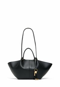 Sac à main en cuir noir avec des côtés larges et évasés, deux poignées, et un porte-clés en or suspendu à l'une des poignées.