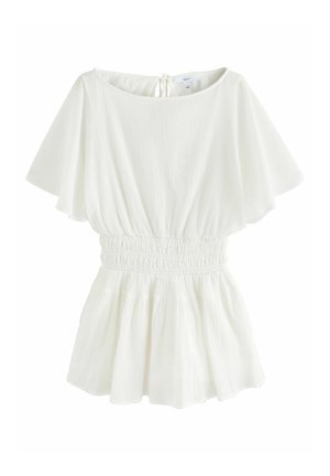 Blouse blanche à manches courtes en tissu texturé, taille élastiquée, ourlet évasé et fermeture à nouer dans le dos au niveau de l'encolure.