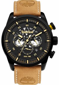 Schwarze Chronograph-uhr mit transparentem Zifferblatt, goldenen Akzenten und Dual-Zeit-Anzeige. Verfügt über ein hellbraunes Lederarmband mit genähten Details.