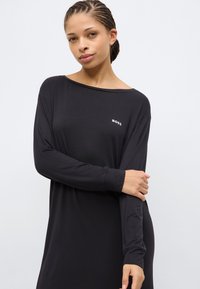 Black long-sleeve dress made of soft fabric, featuring an off-shoulder neckline and a small white "BOSS" logo on the chest.