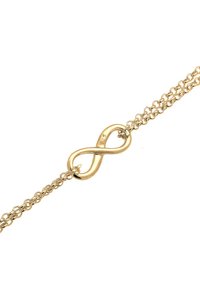 Bracciale color oro con un design a catena e un simbolo dell'infinito al centro, messo in risalto da una finitura lucida e anelli testurizzati.
