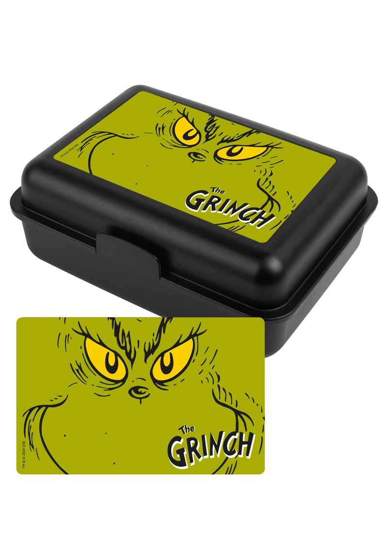 Lunch box nero con coperchio verde che presenta il viso di un Grinch in stile cartone animato e occhi gialli. Include un biglietto abbinato con lo stesso design.