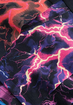 Colorful fabric featuring a lightning bolt pattern in red, pink, purple, and black. Smooth texture with fine stitching along the edges.