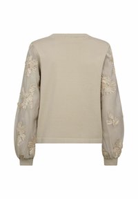 Beige gebreide trui met doorschijnende pofmouwen met bloemrijke borduursels. Eenvoudige ronde halslijn, geribbelde boorden en zoom.