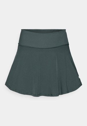 Dark teal athletic skirt with a flared silhouette, elastic waistband, and smooth texture. Features a small logo on the lower right side.