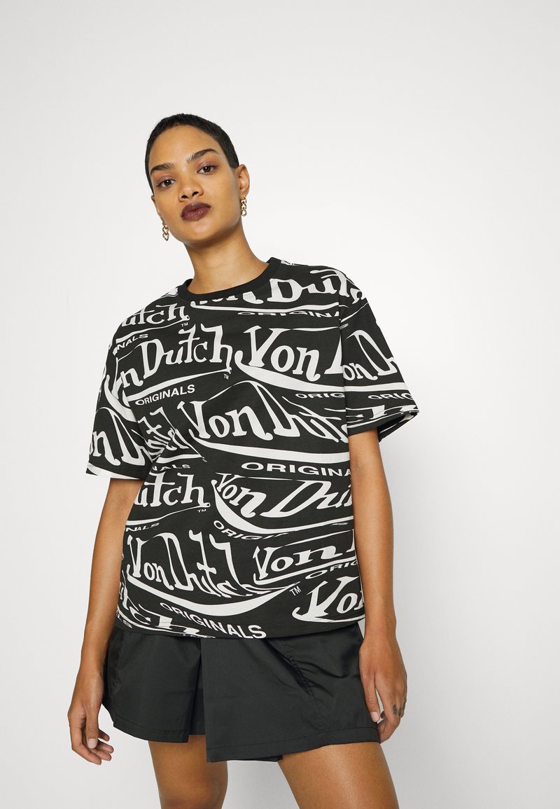 Black short-sleeve t-shirt featuring a white repeating "Von Dutch" logo pattern, round neckline, and relaxed fit, paired with black shorts.