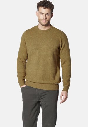 Olive green sweater with a textured knit, round neckline, ribbed cuffs, and hem; worn with dark gray trousers, featuring subtle flecks.