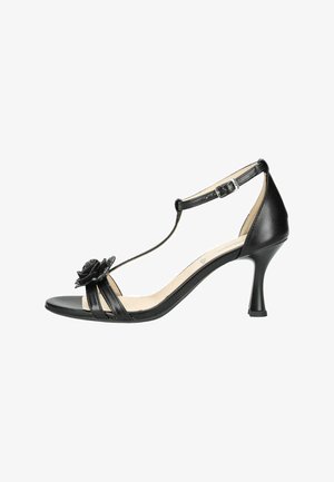 Sandale à talons hauts pour femme en cuir noir avec bride à la cheville, bout ouvert, et fleur noire décorative sur la bride avant.