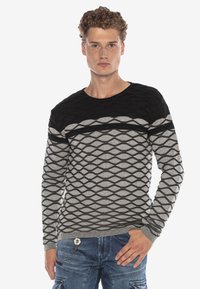 Strickpullover in Schwarz und Grau, mit einem strukturierten Muster aus Rautenformen. Rundhalsausschnitt und lange Ärmel, mit einem taillierten Bund.