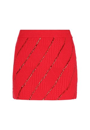 Red knitted mini skirt featuring a textured diamond pattern and diagonal lines embellished with gold sequins.