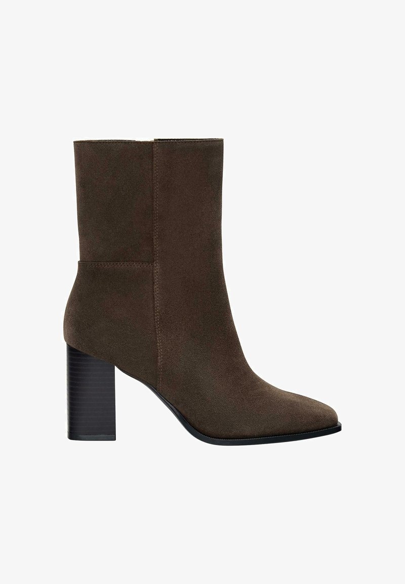 Botte de cheville en suede marron avec un bout pointu, une finition mate et un talon en bloc noir strié. Texture lisse et design sans couture.