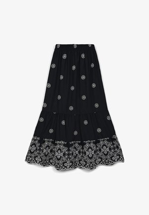 Black tiered skirt featuring white floral embroidery, elastic waistband, and scalloped hem. Lightweight fabric with a flowing design.