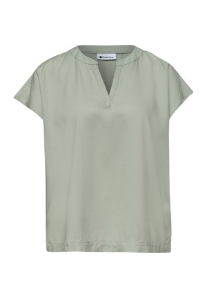 Blouse vert clair à manches courtes avec col en V et col rond, en tissu lisse, présentée à plat sur fond blanc.