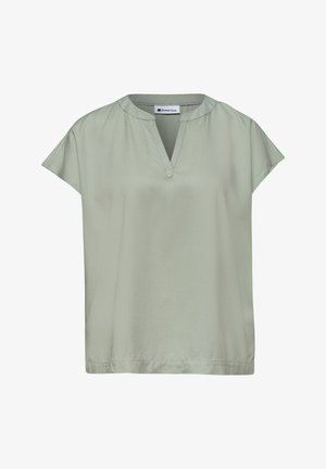 Blouse vert clair à manches courtes avec col en V et col rond, en tissu lisse, présentée à plat sur fond blanc.