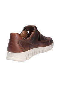 Brown leather sneaker with a textured finish, open sides, and a white rubber sole featuring a wavy pattern.
