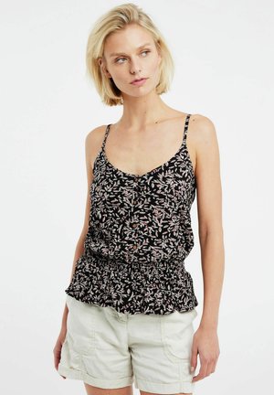 Black floral tank top with thin straps, ruffled hem, and button detail. Features a print of light pink leaves on a dark background.