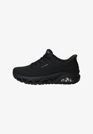 Baskets de sport Skechers noires avec fermeture à lacets, semelle rembourrée incluant une poche d'air visible, et logo de la marque sur le côté et la languette.