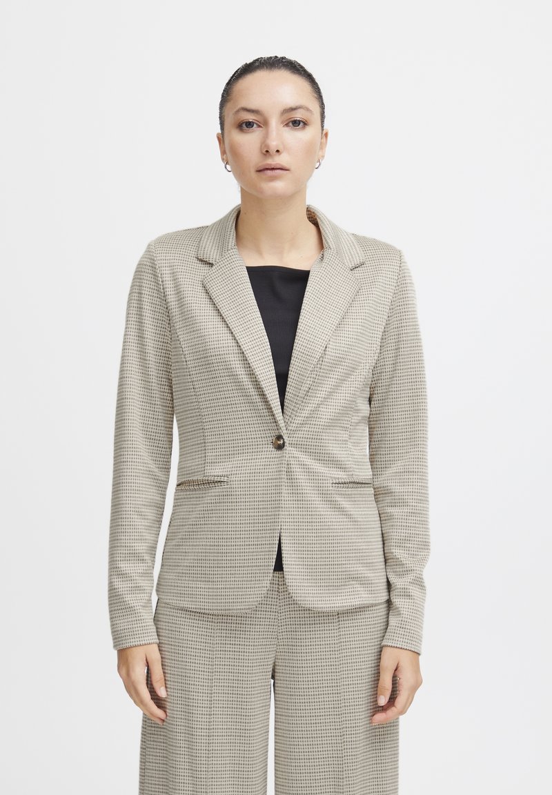 Beige houndstooth patterned blazer with a single button closure and notched lapels, featuring two front pockets and a tailored fit.