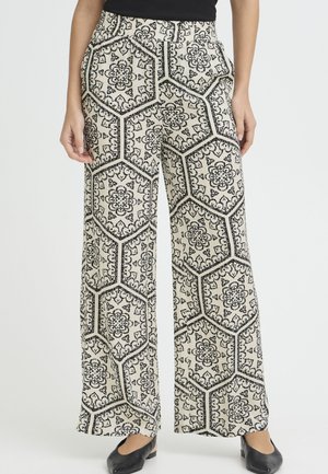 Pantaloni a gamba larga realizzati in tessuto leggero, con base crema e un audace motivo esagonale nero arricchito da accenti floreali.