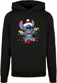 Felpa nera con cappuccio che presenta un personaggio stampato con grandi orecchie, un cappello di Babbo Natale e luci di Natale colorate nelle mani.