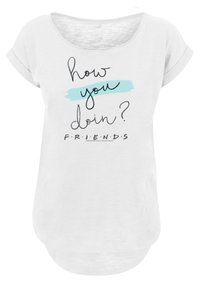Hvit T-skjorte med korte ermer og rund hals. Har teksten "how you doin'?" i svart med et blått detalj, og "FRIENDS" under i svart.