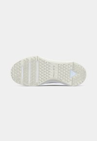 Shoe sole featuring a textured white rubber design with triangular patterns and grooves for grip. Slightly raised branding detail present.