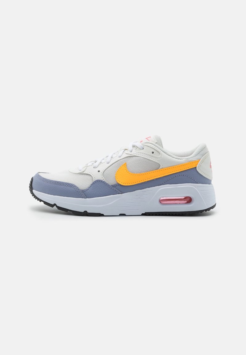 Nike Air Max sneaker in white, grey, and orange. Features a mesh upper, leather accents, round toe, and visible air cushioning in the sole.