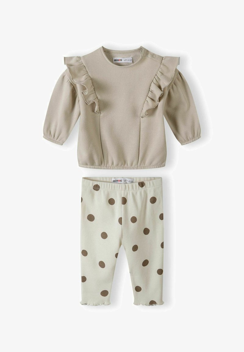 Šviesiai smėlinės spalvos ilga rankovėmis pūsta palaidinė su apvaliu kaklu; grietinėlės spalvos leggingai su ruda taškeliais. Minkšta medžiaga, elastinga juosmens juosta ir pūstieji rankogaliai.