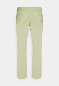 Light green pants with a straight-leg design, elastic waistband, two back pockets, and subtle stitching details. Smooth cotton material.