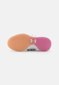 White athletic shoe sole with pink and orange sections; textured rubber surface with a logo on the side. Features a grip pattern.