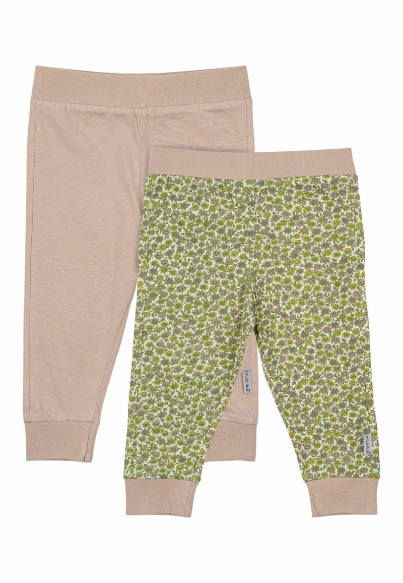 Två par barnleggings: ett par enfärgade ljusbeige och ett par med grön blommönster. Båda har elastiska midjeband och manschetter.