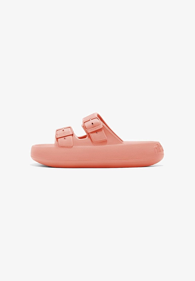 Sandal de color rosa pastel con dos hebillas ajustables, con una suela gruesa y superficie texturizada para mayor agarre.