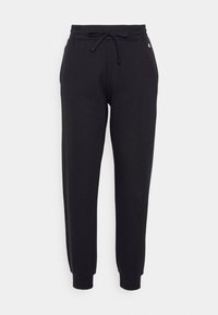 Svarta sweatpants med dragsko i midjan, avsmalnande ben och ribbad mudd. Tillverkade av mjukt tyg med en liten logotyp på framsidan.