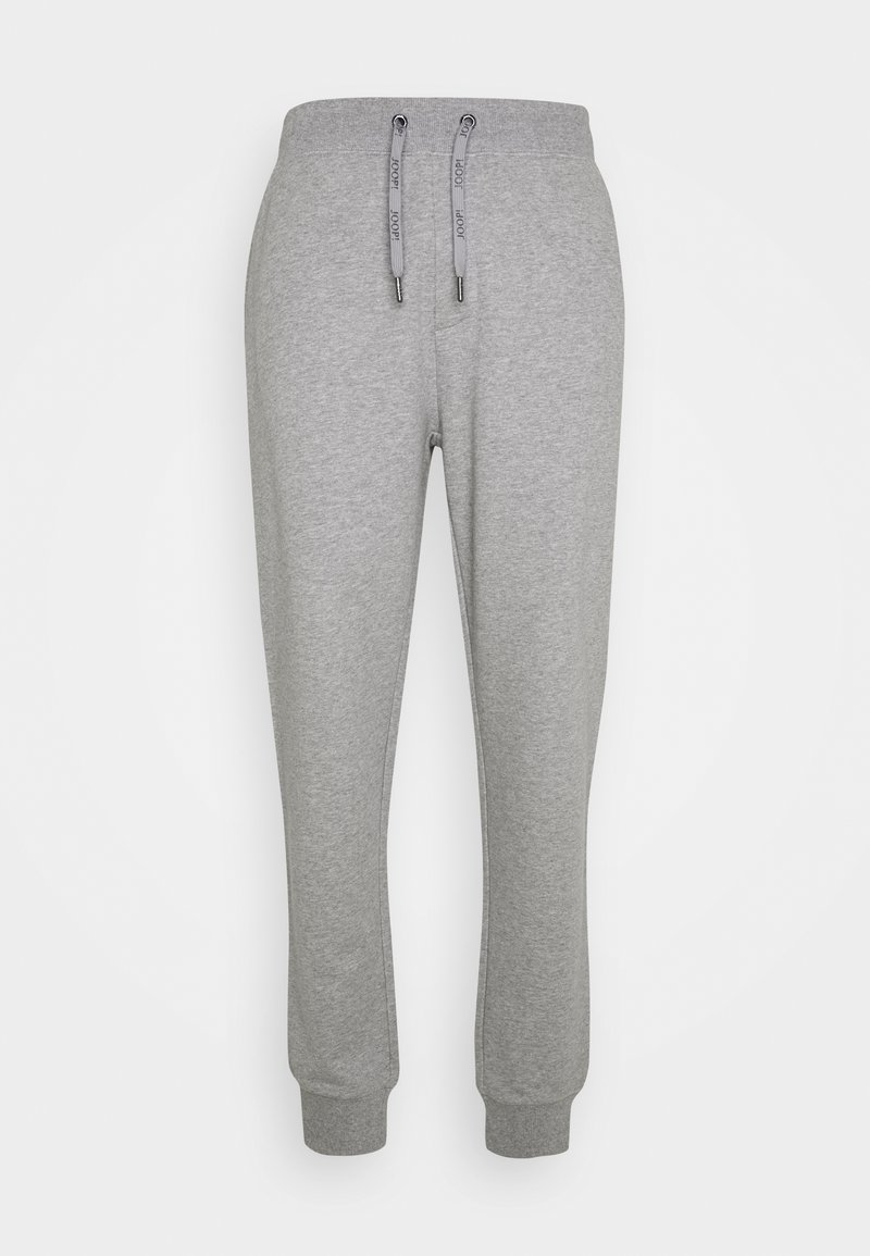 Pantalones de chándal grises hechos de una tela suave, con una cintura elástica con cordones y puños acanalados en los tobillos.