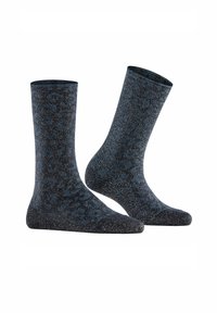 Een paar diepblauwe sokken met zwarte luipaardvlekken en zilveren glitters, naast elkaar weergegeven op een witte achtergrond.