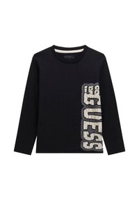 Maglietta nera a maniche lunghe con motivo a testo crackato che scrive "GUESS" verticalmente sul lato destro e colletto rotondo a coste.