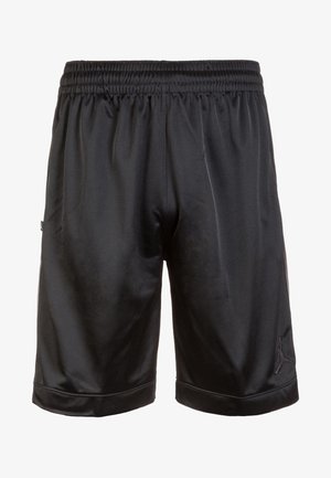 Shorts de sport noirs avec une taille élastique, un tissu lisse et un petit logo Jordan près de l'ourlet en bas de la jambe droite.