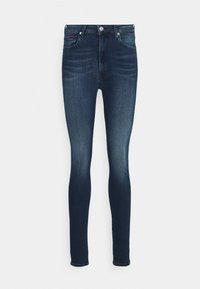 Jeans skinny de color azul oscuro, confeccionados en denim con una textura suave, que presentan un diseño clásico de cinco bolsillos y un cierre de botón único en la cintura.