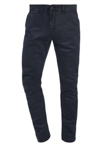 Donkerblauwe katoenen broek met een slim fit, voorzien van een rits en knoopsluiting, voor- en achterzakken en een subtiele stoftextuur.