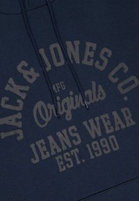 Navy blue hoodie with a textured print. Features include "JACK & JONES CO." and "Originals Jeans Wear EST. 1990" in contrasting color.