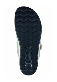 Black rubber outsole featuring a wavy pattern. The shoe has a light-colored upper with cushioning material visible along the edges.