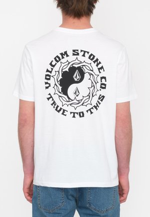 White cotton t-shirt featuring a large black graphic with swirling design and text that says "VOLCOM STONE CO. TRUE TO THIS" on the back.
