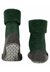 Calze verdi e accoglienti con un bordo peloso e una base in feltro grigio scuro. La suola presenta un motivo di grip in gomma bianca testurizzata per una migliore aderenza.