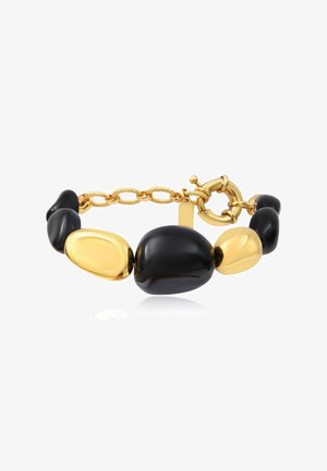 Bracelet avec de grosses perles ovales lisses noires et dorées irrégulières alternées et une chaîne dorée avec un fermoir rond à bascule.